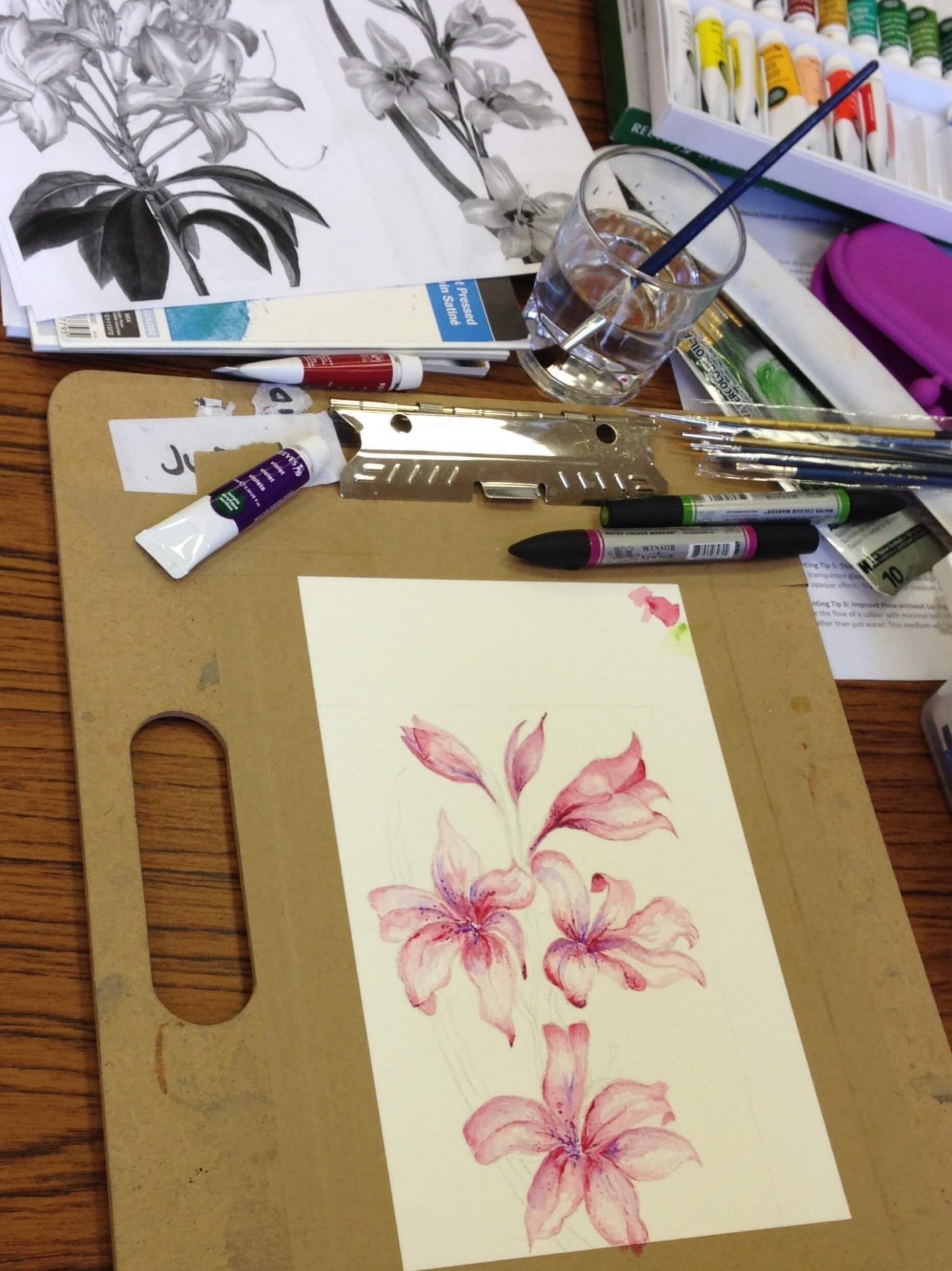 Artwork of pink flowers on a drawing board